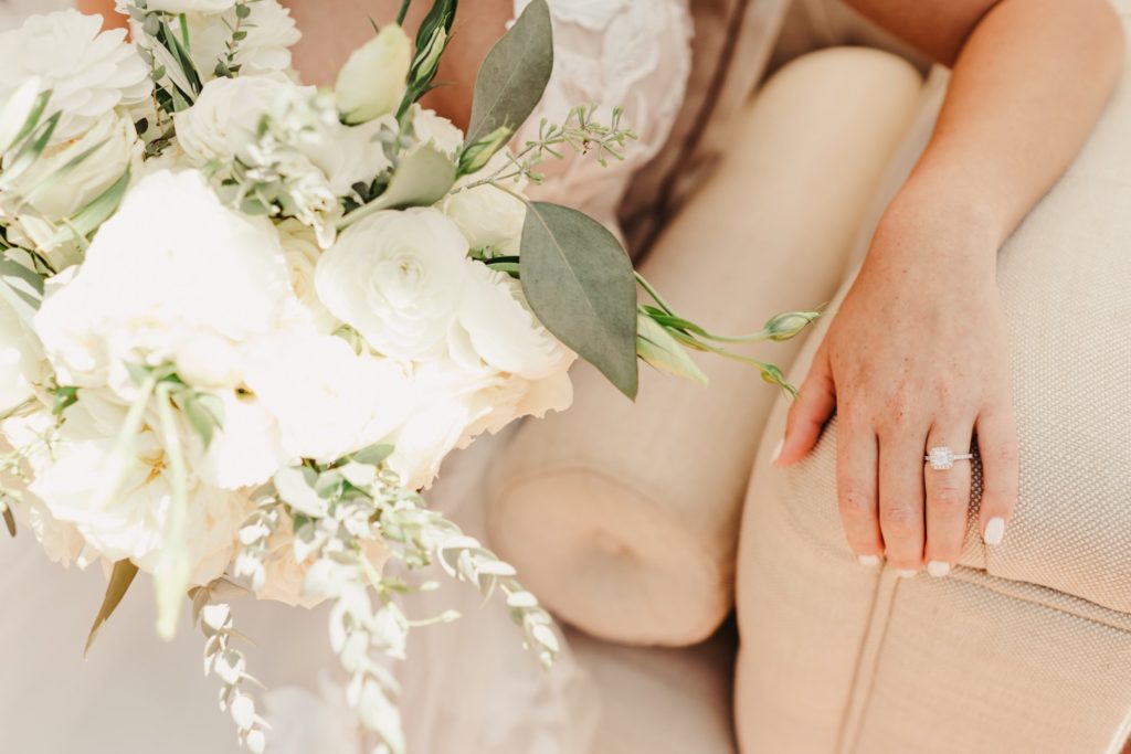 Bouquet and bride's hand with wedding ring