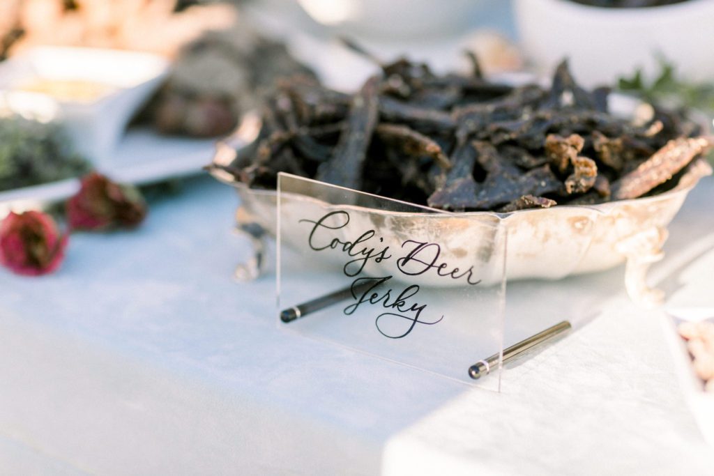 Groom's homemade deer jerky featured at their cocktail hour
