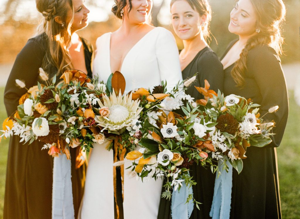 Bride and her maids holding modern edgy fall bouquets