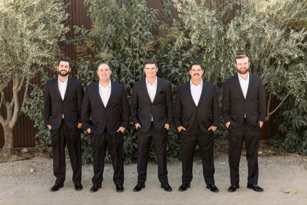 The groomsmen looking dapper in their black suits