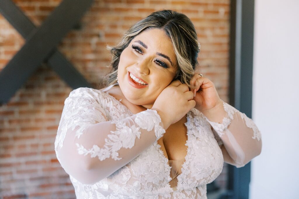 Bride putting earrings on at La Cuesta Ranch Wedding Designed by Janet Tacy of San Luis Obispo Wedding Planner Sandcastle Celebrations captured by Jen Rodriguez Photography