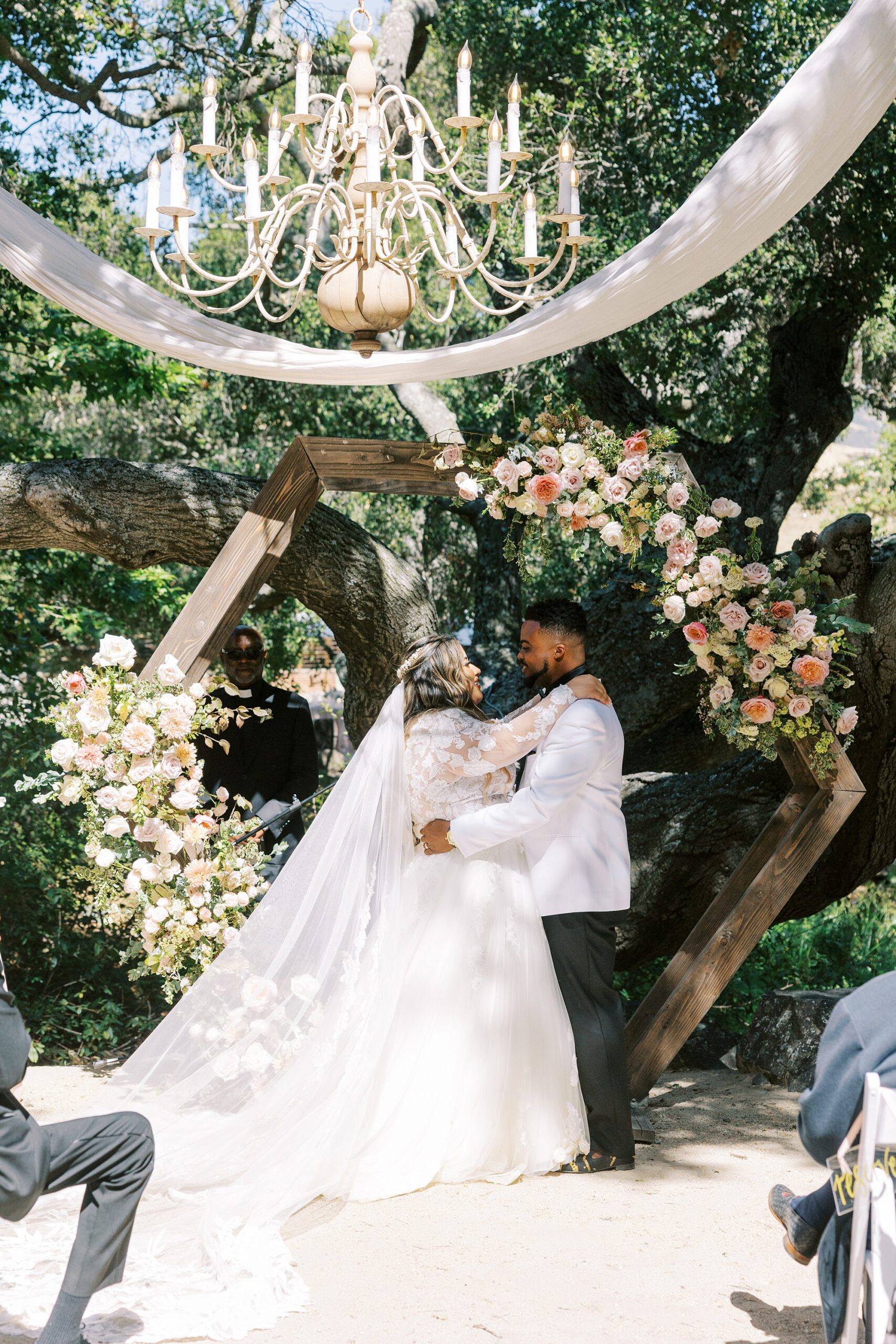 Bride and groom with octagon ceremony arbor at La Cuesta Ranch Wedding Designed by Janet Tacy of San Luis Obispo Wedding Planner Sandcastle Celebrations captured by Jen Rodriguez Photography