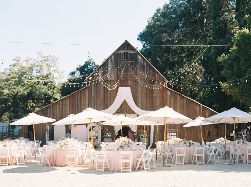 pink and ivory reception with umbrellas at La Cuesta Ranch Wedding Designed by Janet Tacy of San Luis Obispo Wedding Planner Sandcastle Celebrations captured by Jen Rodriguez Photography
