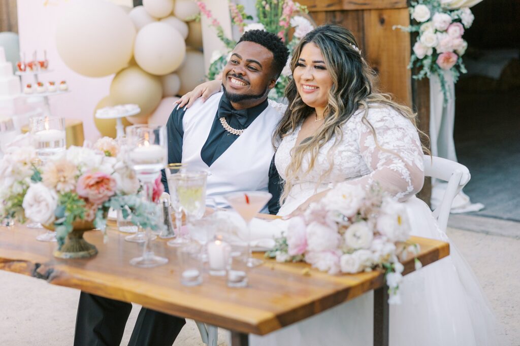 Bride and groom at sweetheart table at La Cuesta Ranch Wedding Designed by Janet Tacy of San Luis Obispo Wedding Planner Sandcastle Celebrations captured by Jen Rodriguez Photography