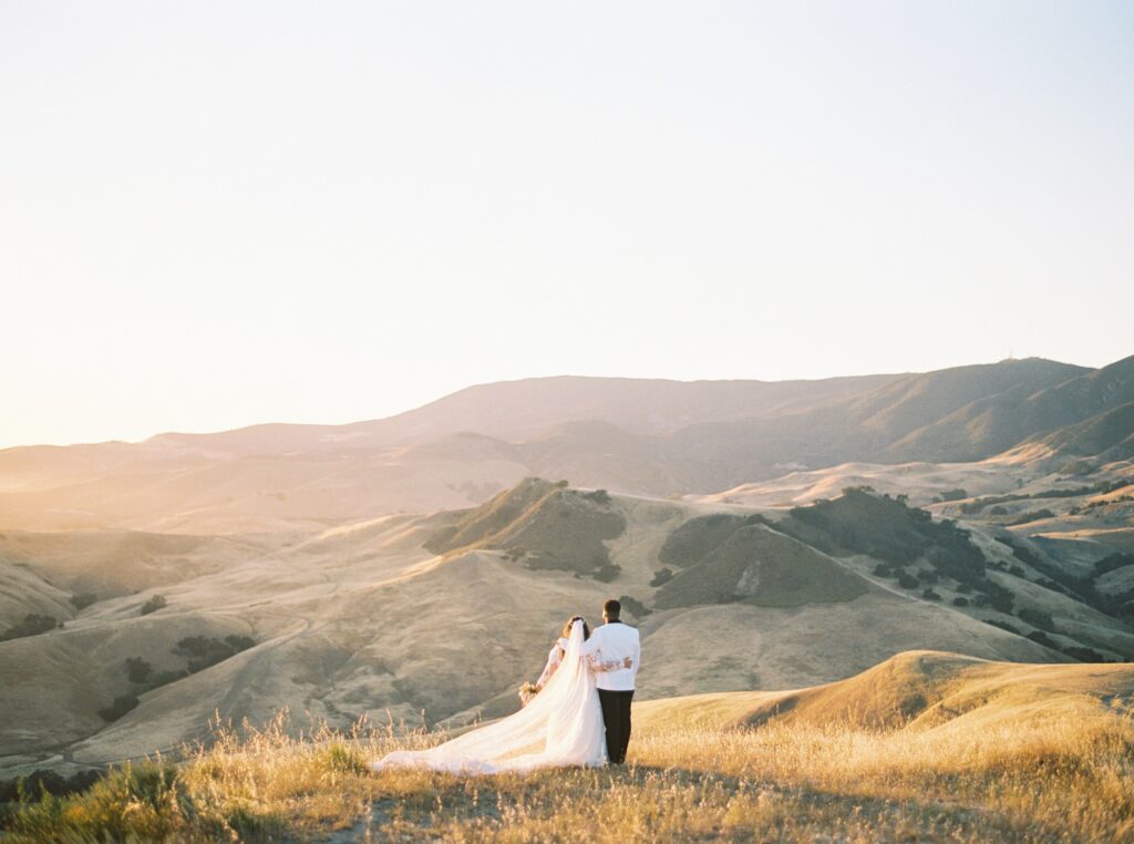 Bride and groom overlooking SLO valley at La Cuesta Ranch Wedding Designed by Janet Tacy of San Luis Obispo Wedding Planner Sandcastle Celebrations captured by Jen Rodriguez Photography
