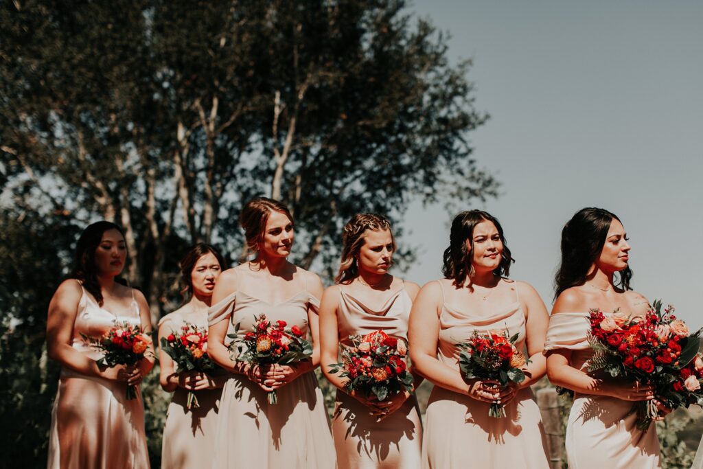 Bridesmaids in nude dresses with bold red florals at Japanese infused wedding at the Arroyo Grande Casitas Estate Wedding by SLO Wedding Planner Sandcastle Celebrations