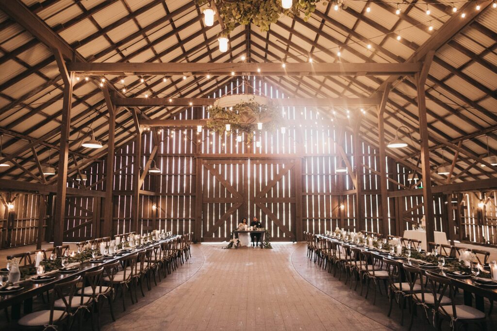 Barn reception with farm house table at White Barn Wedding coordinated by Janet Tacy of Edna Valley Wedding Planner Sandcastle Celebrations