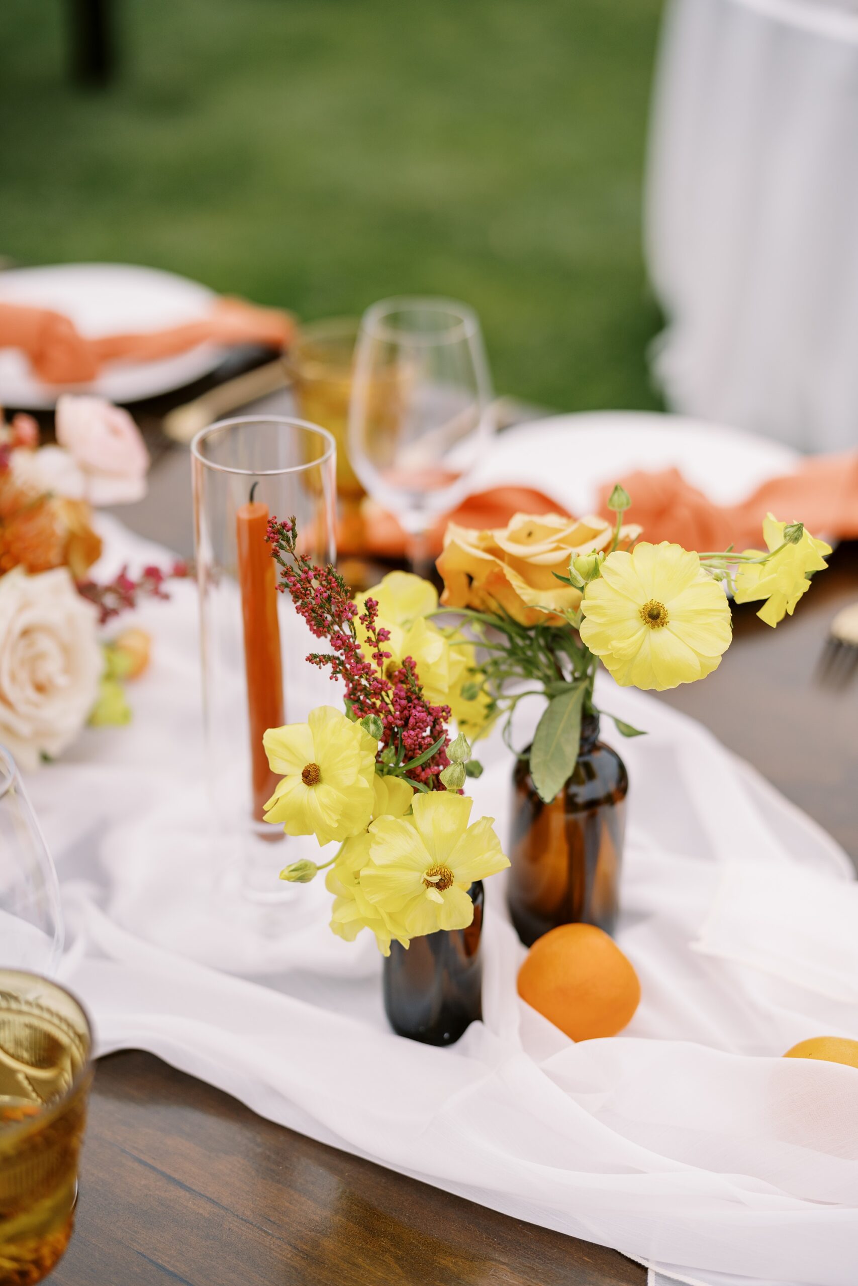 Yellow and orange florals at unique 70s vibe colorful tangerine wedding at Casitas Estate by the best san luis obispo wedding planner Janet Tacy of Tacy and co.