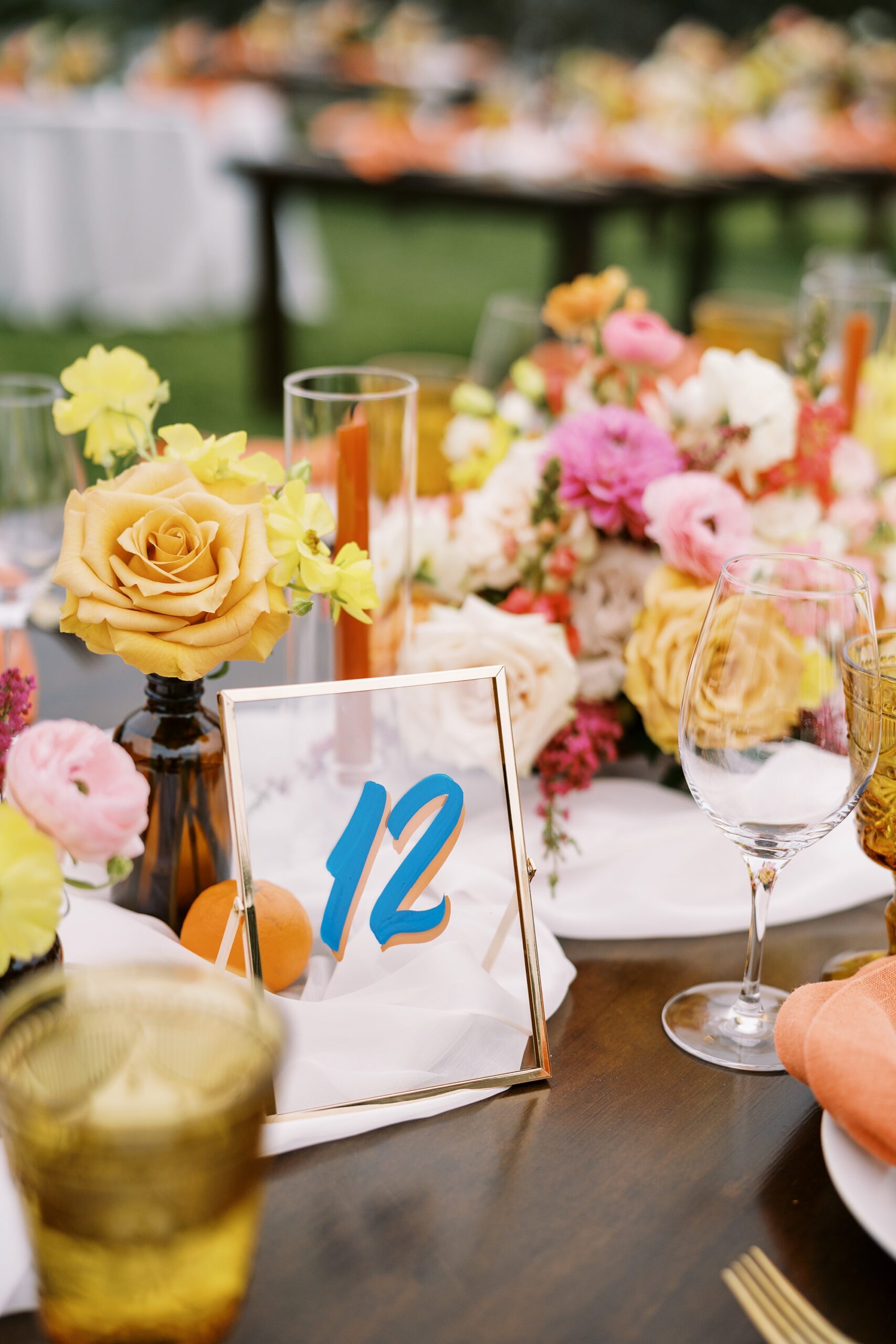 Glass with painted lettering table cards at unique 70s vibe colorful tangerine wedding at Casitas Estate by the best san luis obispo wedding planner Janet Tacy of Tacy and co.