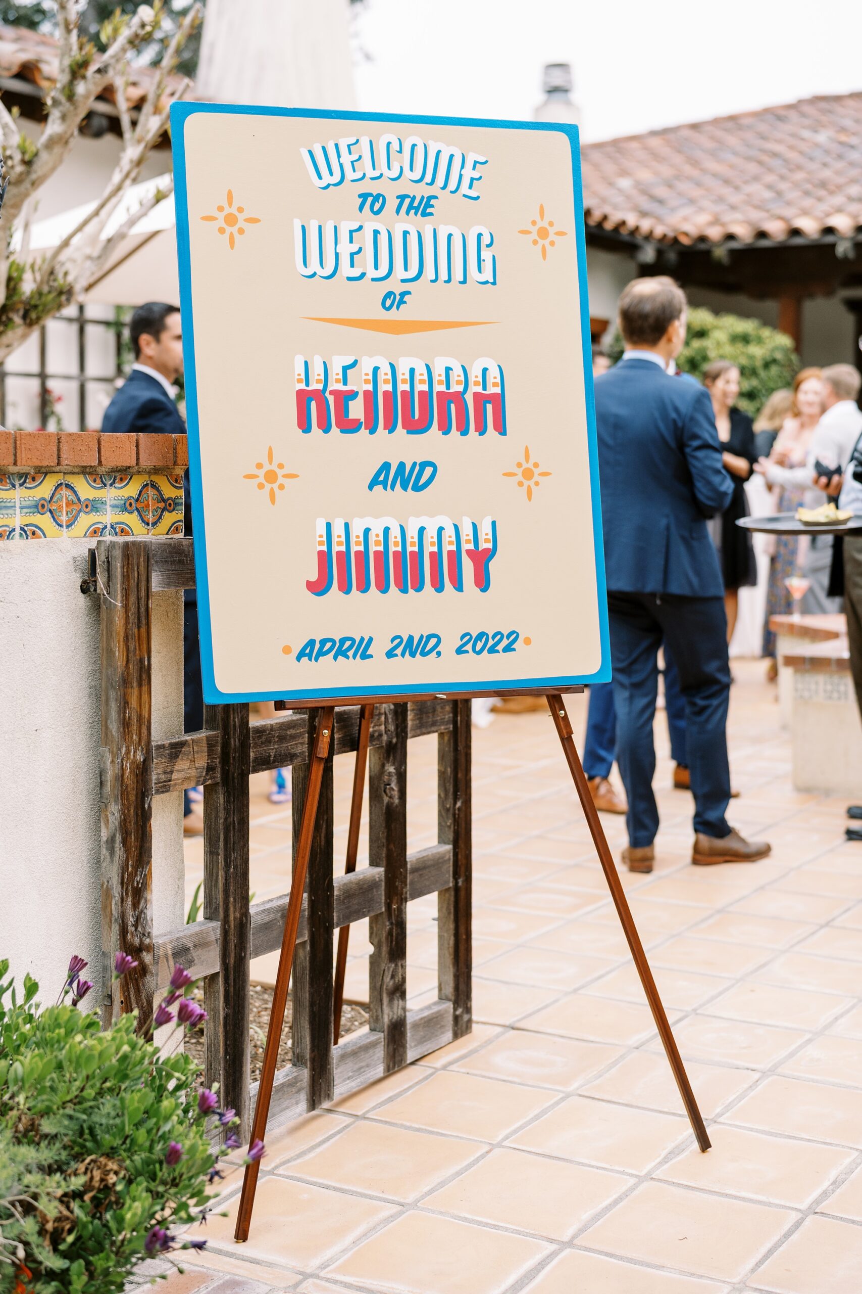 Ceremony welcome sign at unique 70s vibe colorful tangerine wedding at Casitas Estate by the best san luis obispo wedding planner Janet Tacy of Tacy and co.